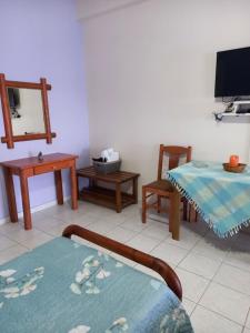 a living room with a table and a tv at Korasida Blue Coast in Akhladherí