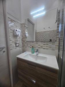 a bathroom with a sink and a mirror at Golden house sicily in Catania +34 photos