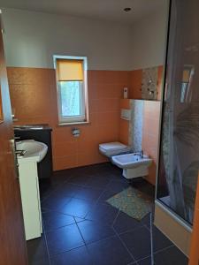 a bathroom with a sink and a toilet and a shower at Lunar in Augustów