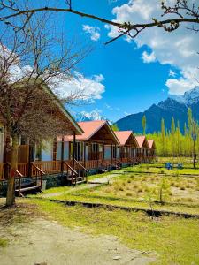 a row of houses with mountains in the background at Greenwood Resort Skardu in Skardu