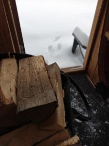 una pila de madera sentada frente a una puerta en Just Like Home Bed & Spa Porsgrunn, en Porsgrunn