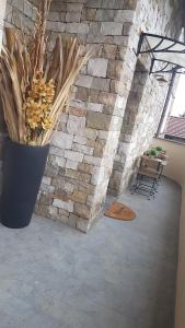 a room with a stone wall and a vase with flowers at ILLUVIA affitto camere in Cornaredo