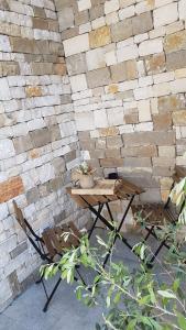 una mesa y sillas frente a una pared de ladrillo en ILLUVIA affitto camere, en Cornaredo