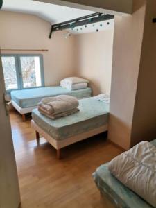 a room with two beds and a mirror at les papillons in Ruoms