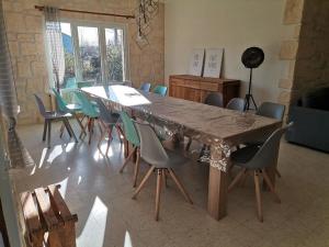 a large wooden table and chairs in a room at les papillons in Ruoms