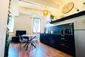 a kitchen with a table and a clock on the wall at Jungle (Play) Room in Le Muy +13 photos
