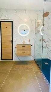 a bathroom with a shower and a sink and a mirror at Jungle (Play) Room in Le Muy