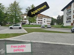 a parking lot with a free public parking sign at Apartman "Plitvice and You" in Plitvička Jezera