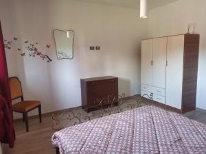 a bedroom with a bed and a dresser at Da Nady in Stia