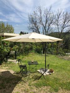 a table and two chairs under an umbrella at Da Nady in Stia