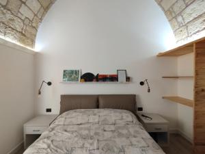 a bedroom with a bed and two night stands at La Casecchia in Porto Cesareo