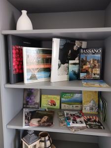 un estante lleno de libros y revistas en Little House Pove del Grappa, en Pove del Grappa