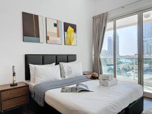 a bedroom with a bed with a large window at Key View - Marina Park in Dubai