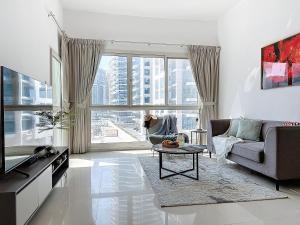 a living room with a couch and a table at Key View - Marina Park in Dubai