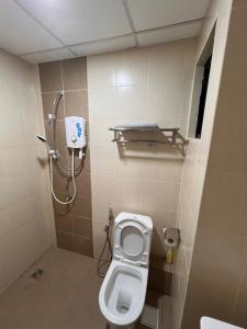 a bathroom with a toilet and a shower at FJ Haven in Penampang
