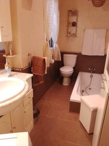 a bathroom with a sink and a toilet and a tub at Terraced house with stunning view close to Mdina in Rabat