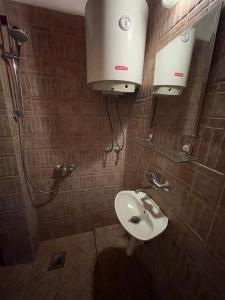 a bathroom with a toilet and a sink at Cave Apartment in Virpazar