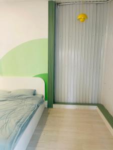 a bedroom with a white bed and a yellow light at SNOW HOUSE HCR in Ho Chi Minh City