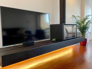a large flat screen tv sitting in a living room at Oceanview 4 U - Close to Lisbon! in Oeiras +57 photos