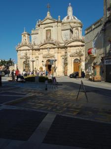 a large building with a cross on the front of it at Terraced house with stunning view close to Mdina in Rabat