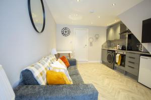 a living room with a blue couch and a kitchen at Rothes Retreat - SJA Stays - Luxury 1 Bed House in Rothes