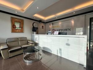 a lobby with a waiting room with a couch and a counter at De UPTOWN Hotel @ Damansara Uptown in Petaling Jaya