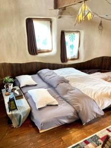 a large bed in a room with two pillows at Tida House - Vacation STAY 07404v in Koshimizu-shigai