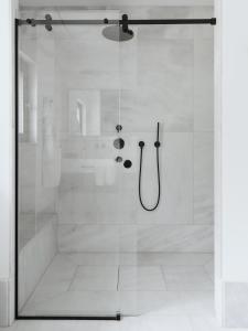 a shower with a glass door in a bathroom at Villa MUSA in Lenno