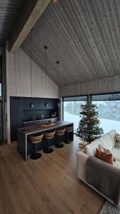 a living room with a kitchen and a christmas tree at havsdalen 57 in Geilo