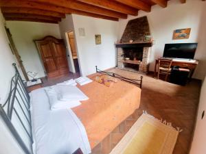 a bedroom with a large bed and a fireplace at La Garzaga Turismo Rurale in Ceresara