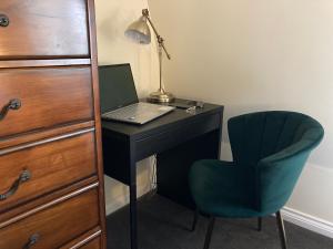 a desk with a laptop and a chair in a room at Cathedral Quarter Apartments in Belfast +22 photos