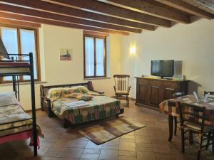 a bedroom with a bed and a tv in a room at La Garzaga Turismo Rurale in Ceresara