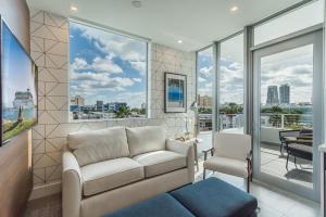 a living room with a couch and a view of the city at MILLA South Beach in Miami Beach