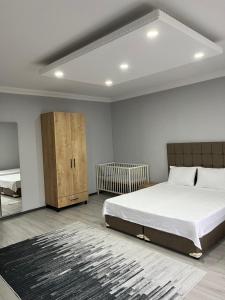 a bedroom with a large bed and a cabinet at Ozn Suit Airport in Arnavutköy