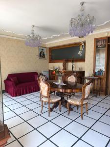 a living room with a table and chairs and a couch at Bed & Breakfast Kalinka in Motta SantʼAnastasia