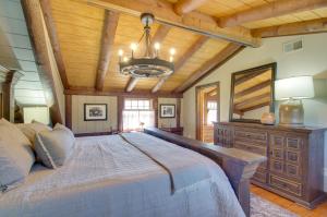 a bedroom with a large bed and a wooden ceiling at Cozy Log Cabin Getaway with Fire Pit and 3 Acres! in Ruckersville