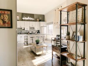 a kitchen with white cabinets and a table at Neyland View Condo - Heart of Downtown Knoxville in Knoxville