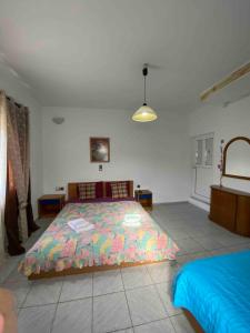 a bedroom with a bed with a colorful comforter at Aggelina in Sárkhos