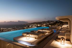 a luxury hotel with a pool with a view at Lovia Mykonos in Mýkonos City