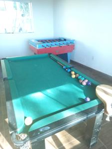a pool table in a room with at POUSADA SÃO LUCAS in Águas de Lindóia