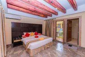 索拉哈的住宿－七星酒店，一间卧室配有一张大床,提供红色和黄色枕头