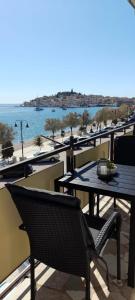 a balcony with tables and a view of the water at Apartman Pida in Primošten