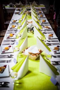 a long table with plates of food and wine glasses at Marine Závlahy in Hrdějovice