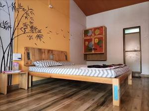 a bedroom with a bed in a room at Sai Homestay in Malvan