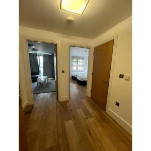 an empty room with a bedroom and a bed at Spacious 1 Bedroom Flat in Kilburn Park F55 in London