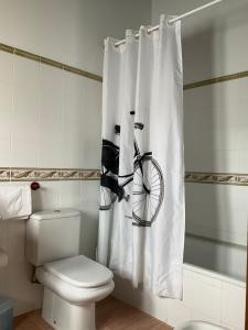 a bathroom with a shower curtain with a bike on it at Casa Milia in Santa María