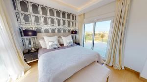 a bedroom with a large bed and a large window at Atico Serenity by Oliva Nova in Oliva +26 photos