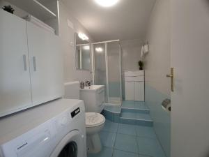 a white bathroom with a toilet and a sink at Eden apartment in Kornić +90 photos