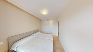 a small bedroom with a bed in a room at Edelweiss by ON Travel in Oliva +12 photos