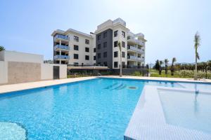 a large swimming pool in front of a building at Edelweiss by ON Travel in Oliva